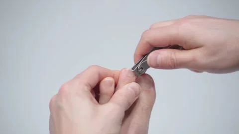 Man is cutting her nails on toes using nippers by herself. Stock Footage 328416748