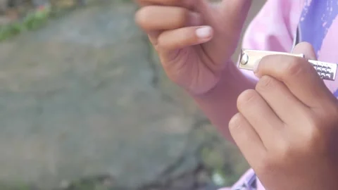 A man is cutting his fingernails using a metal nail clipper Stock Footage 333343112