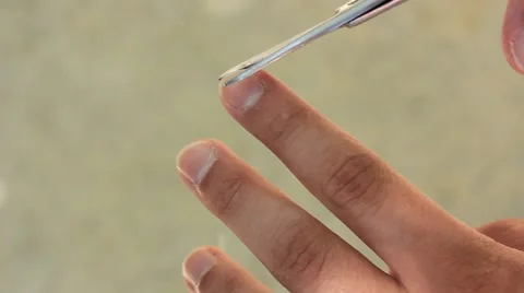 Man cutting his nails with scissors Stock Footage 50610347
