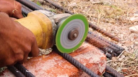Man is cutting iron road with help of iron cutter machine with golden sparkli Stock Footage 152450189