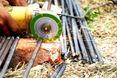 Man is cutting iron road with help of iron cutter machine Stock Photos