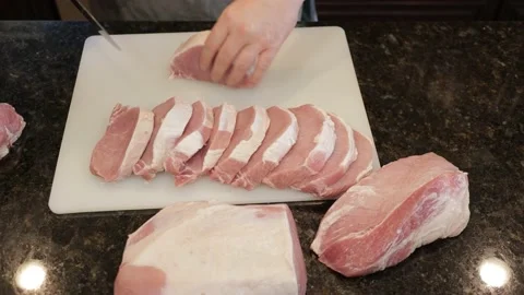 Man Cutting Large Pork Meat In A Kitchen Stock Footage 138382019