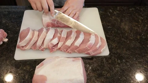 Man Cutting Large Pork Meat In A Kitchen Stock Footage 138382023