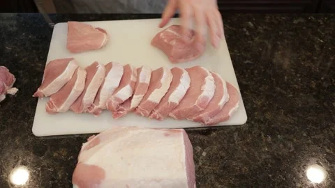 Man Cutting Large Pork Meat In A Kitchen Stock Footage 138382101