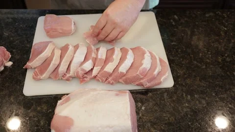 Man Cutting Large Pork Meat In A Kitchen Stock Footage 138382513