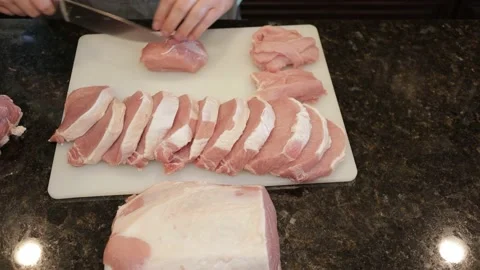 Man Cutting Large Pork Meat In A Kitchen Stock Footage 138382610