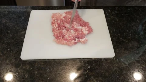 Man Cutting Large Pork Meat In A Kitchen Video stock 138384881