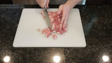 Man Cutting Large Pork Meat In A Kitchen Stock Footage 138384979