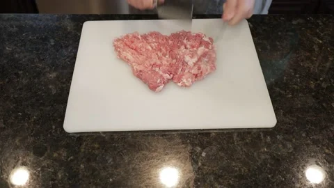 Man Cutting Large Pork Meat In A Kitchen Stock Footage 138385259