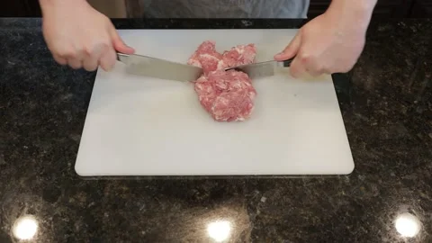 Man Cutting Large Pork Meat In A Kitchen Stock Footage 138385286
