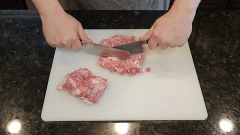 Man Cutting Large Pork Meat In A Kitchen Stock Footage 138385625