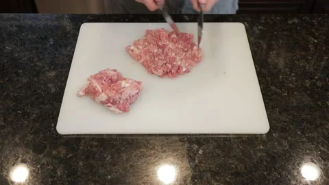 Man Cutting Large Pork Meat In A Kitchen Stock Footage 138385643