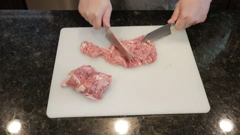 Man Cutting Large Pork Meat In A Kitchen Stock Footage 138385981