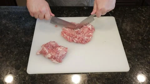 Man Cutting Large Pork Meat In A Kitchen Stock Footage 138385993