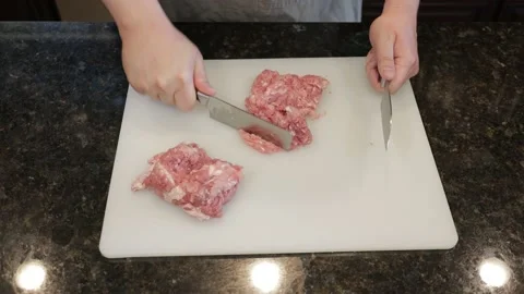 Man Cutting Large Pork Meat In A Kitchen Stock Footage 138386060