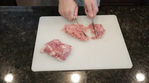 Man Cutting Large Pork Meat In A Kitchen Stock Footage 138386176