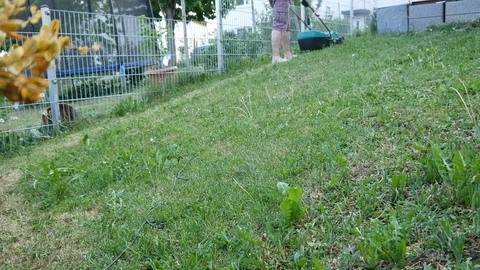 Man cutting lawn with grass mower Stock Footage 89859521