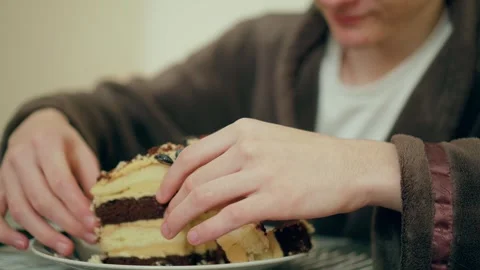 Man cutting layered cake with knife. Male slicing chocolate dessert on plate Stock Footage 306477939