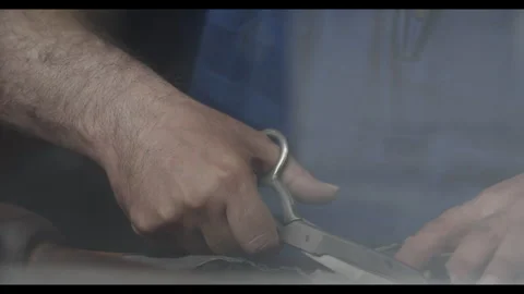Man cutting leather with scissors Stock Footage 271259580