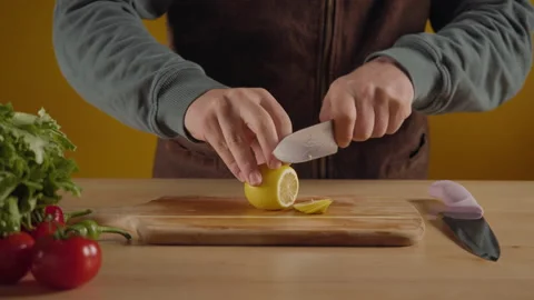 Man cutting a lemon on the chopping board. Stock Footage 171593841