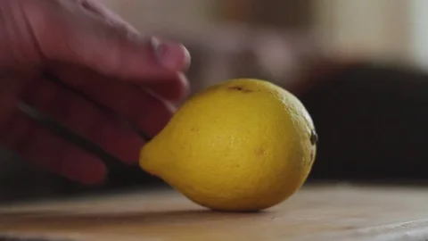 A man is cutting a lemon Stock Footage 77589767