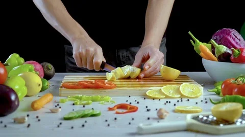 Man is cutting lemon in the kitchen, slicing lemon Stock Footage 98202077