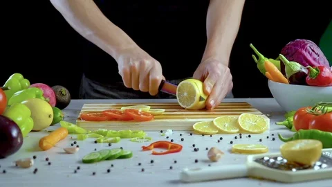 Man is cutting lemon in the kitchen, slicing lemon Stock Footage 98202213