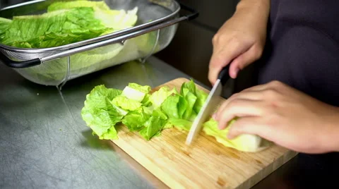 Man Cutting Lettuce on Board Cutting with Ceramic White Knife 60 fps Stock Footage 59786942