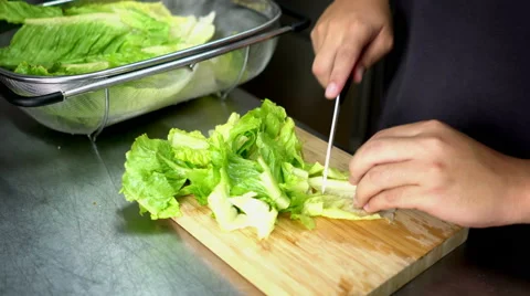Man Cutting Lettuce on Board Cutting with Ceramic White Knife - 4K Resolution Stock-Footage 59787063