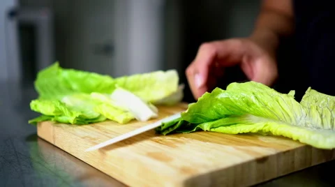 Man Cutting Lettuce on Board Cutting with  Ceramic White Knife - Close Up 60 Stock Footage 59787446