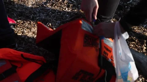 Man cutting lifejacket Stock Footage 145911683