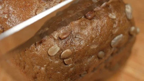Man cutting a loaf of bread. Stock Footage 82670078