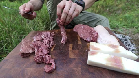 Man Cutting Meat on a Camping Trip 스톡 동영상 280120158