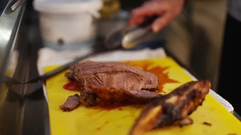 A man is cutting meat on a cutting board Video stock 296056668
