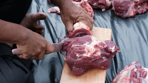 A man cutting meat Stock Footage 244838947