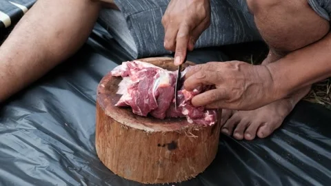 A man cutting meat Stock Footage 244839078