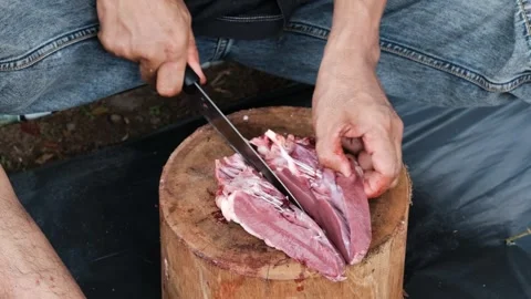 A man cutting meat Stock Footage 244839398