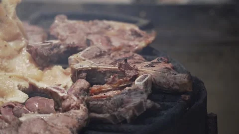 Man cutting the meat while it is on the grill Video stock 187648550