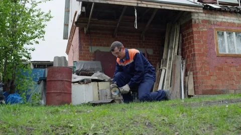 Man cutting metal with a tool Stock Footage 195859468