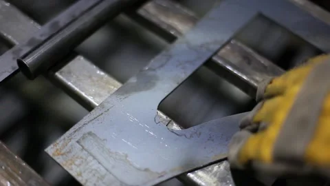 Man cutting metal using grinding machine in hangar Stock Footage 139586254