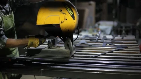 Man cutting metal using grinding machine in hangar Stock Footage 139591391