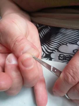Man cutting nails with scissors Fotos de archivo
