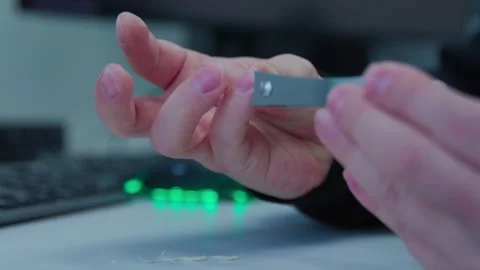 A man cutting nails on a workplace with nails cutter Stock Footage 273123040