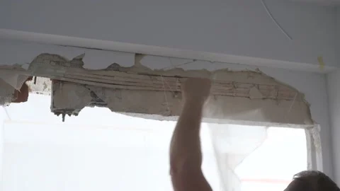 Man cutting off a net from under plaster 動画素材 170342083