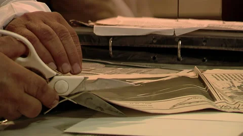 Man Cutting a Newspaper While Storing Clippings of Chamame Folk Music Articles. Stock Footage 238419842
