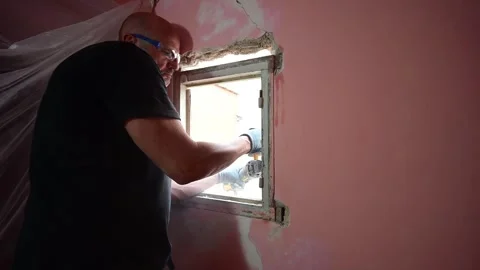 Man cutting old window frame with grinder during renovation Video stock 347640695