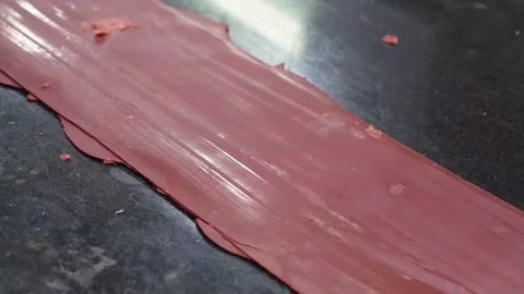 A man cutting or scratching a wax piece. An artist making pattern on wax in.. Stock Footage 244741419
