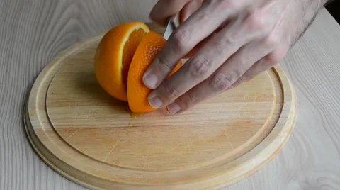 A man cutting an orange Stock Footage 48139677