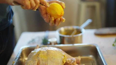A man is cutting an orange in half and squeezing it Stock Footage 295368093