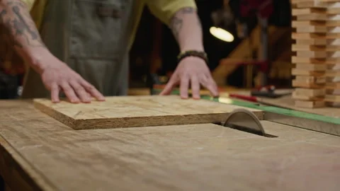 Man Cutting Osb Wood Panel with Table Saw in Carpentry Workshop Stock Footage 340400286